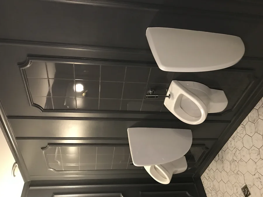 Restroom detail showing decorative tile pattern and fixture arrangement