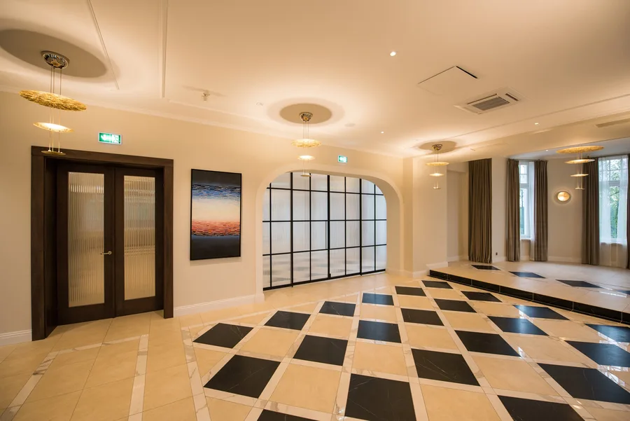 Staircase and corridor junction showing heritage proportions and warm lighting