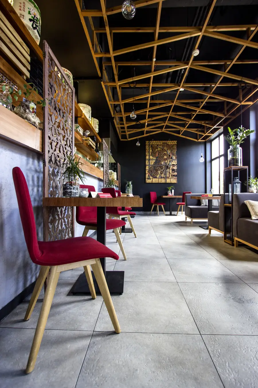 Interior: ground floor overview, bar counter and metal screens left, red chairs, Klimt, ceiling lattice