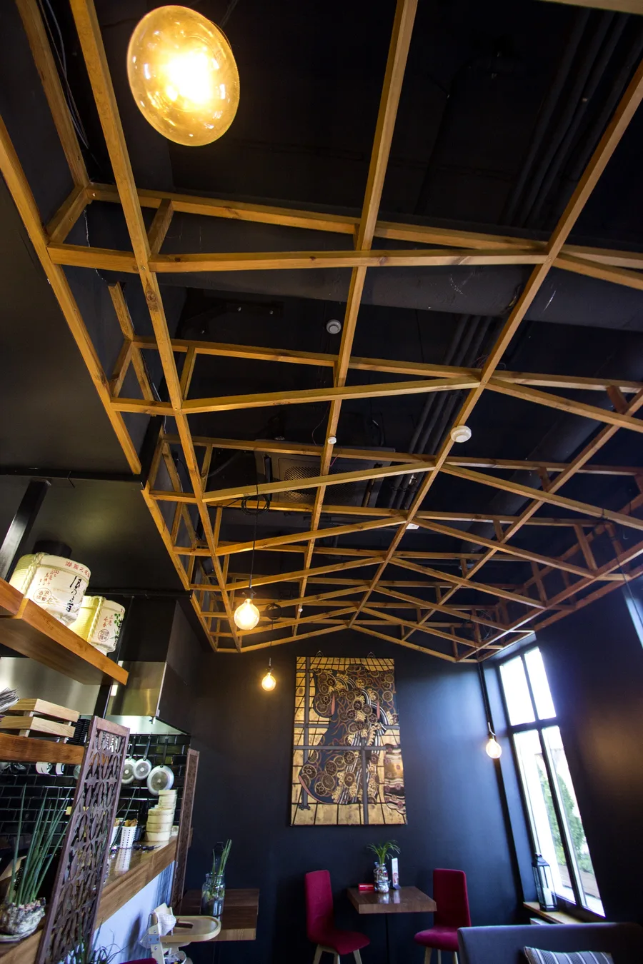 Interior: wooden ceiling lattice close-up from below with orange pendant, Klimt panel and window visible