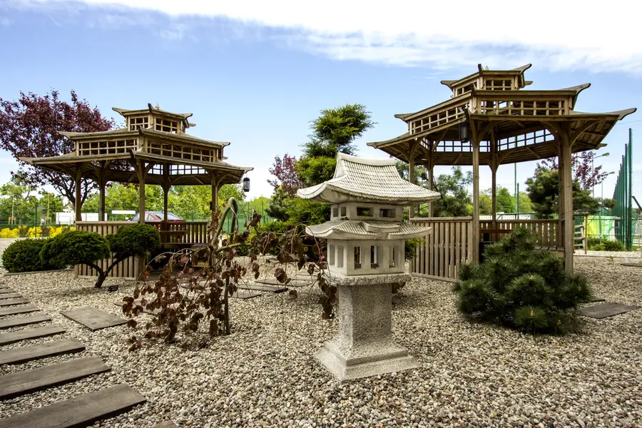 Exterior: Japanese garden full view — three pagodas, stone lantern, stepping stones, gravel, ornamental trees