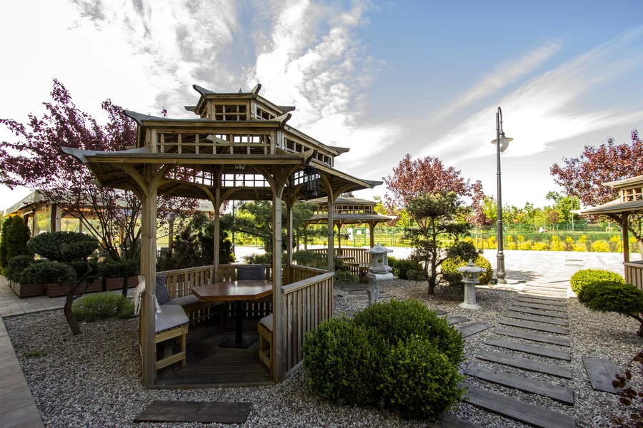 Exterior: pagoda seating — large pagoda interior with bench seating, stone lanterns, multiple pagodas behind